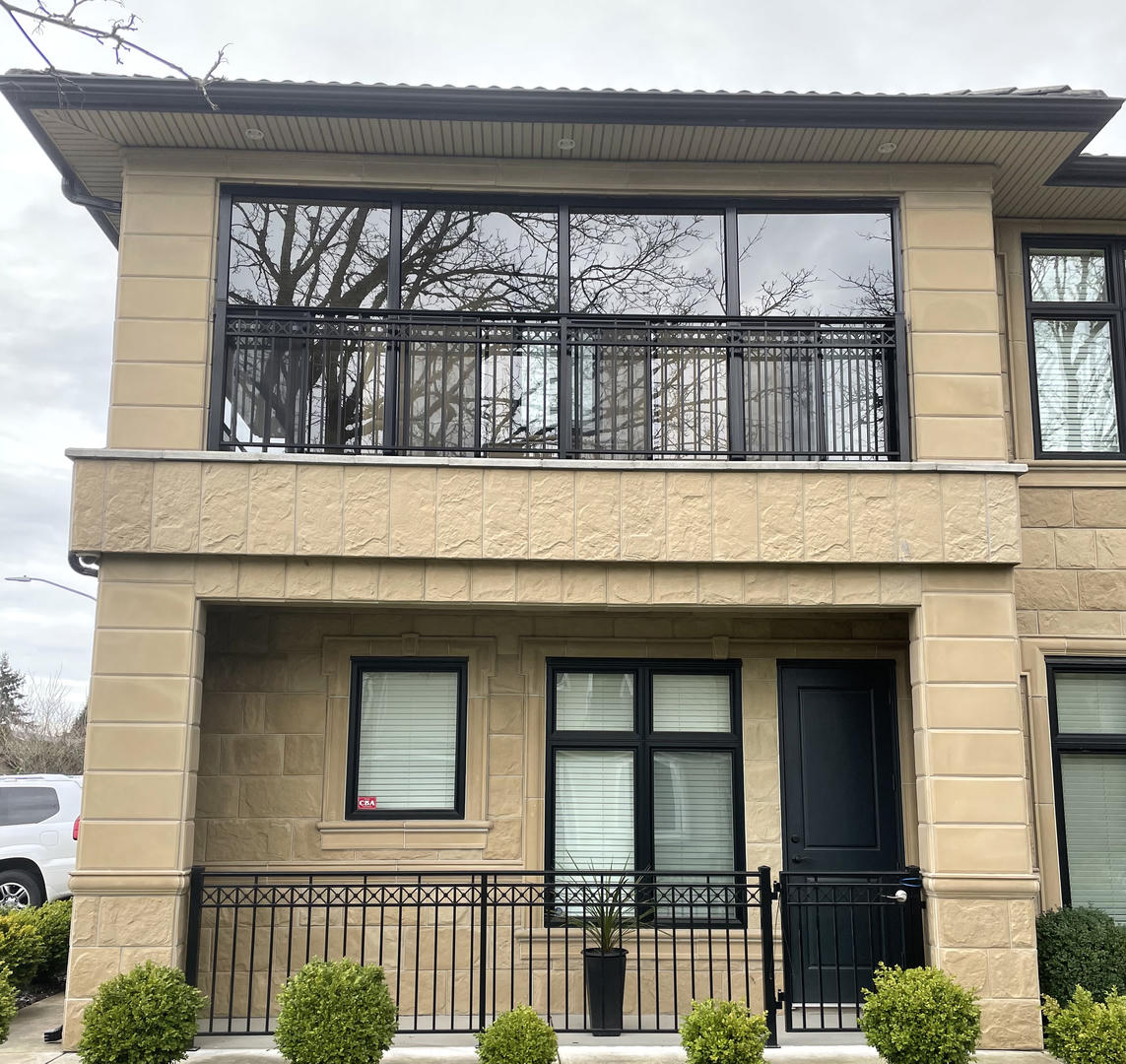 Balcony enclosure with two levels of black railings
