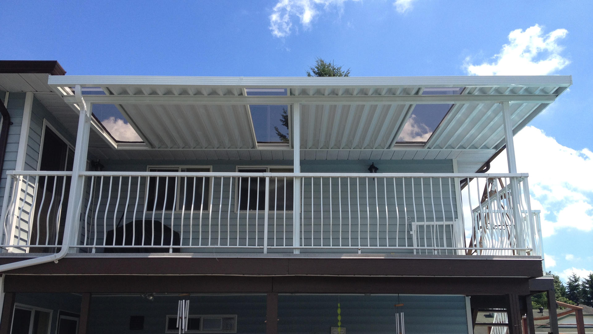 White aluminum patio cover with partial glass covering